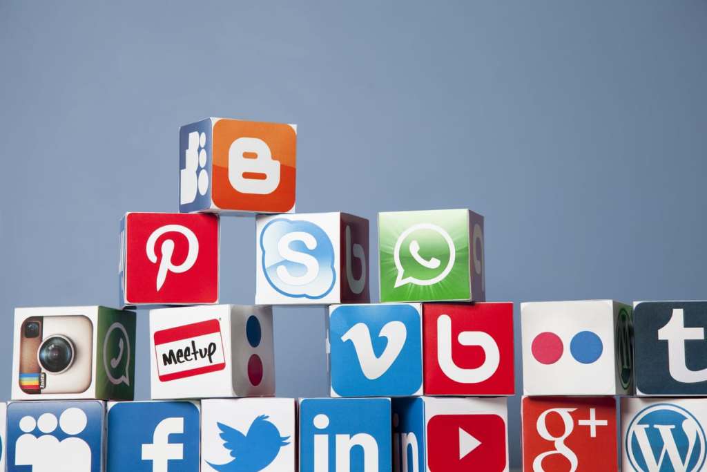 5 Ways to Meet New People on Assignment London, United KIngdom- September 24, 2013: Social media logos printed onto handmade cubes. Logos include Facebook, You tube, twitter, pinterest, linkedin and google plus. Social media uses web and mobile technology to connect people