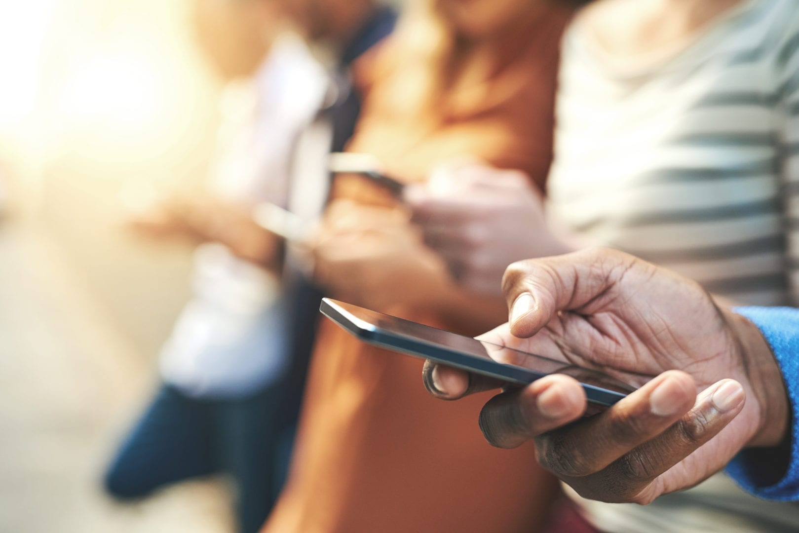 The Best Mobile Apps for Travel Nurses Shot of an unrecognizable group of people social networking outside