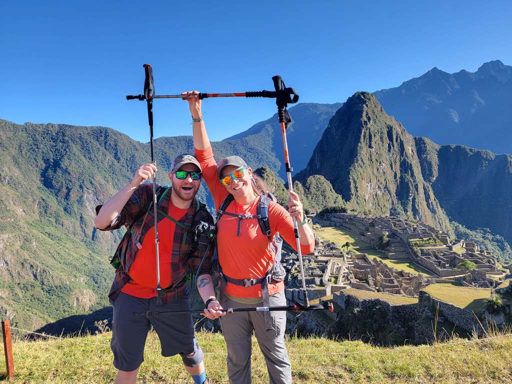 A Career Leading to Love in More Ways Than One Travel nurses Zane and Ally posing with hiking poles in front of Machu Picchu
