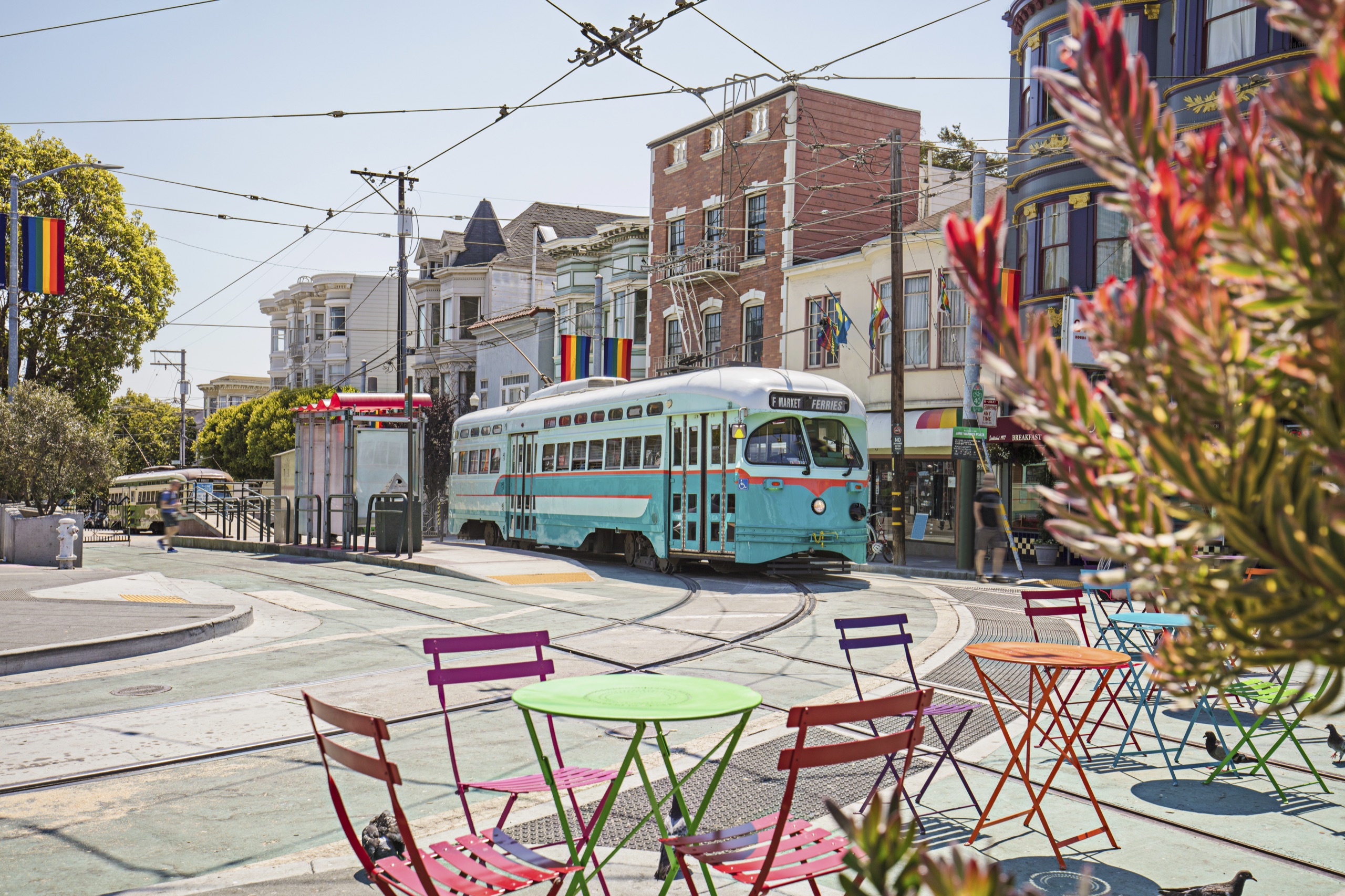 Streetcar in San Francisco’s Castro District with Pride flags, LGBTQ-friendly neighborhood with historic charm.